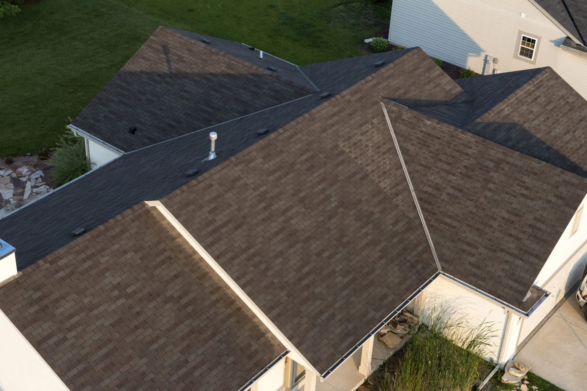 Aerial view of a home with a brown architectural shingle roof